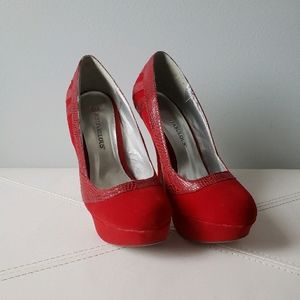 Red platform pumps with red snakeskin accent
